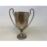 A silver two-handle trophy, Birmingham 1919, 13.2 ozt, 20.5 cm high marks rubbed, feels solid,