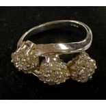 ***Withdrawn***An 18ct white gold and diamond triple flowerhead ring, approx. ring size N, 5.7 g (