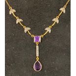 A modern gold plated Art Nouveau style pendant necklace inset with purple and white stones Report by