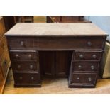 An early 19th century mahogany kneehole desk, with an arrangement of seven drawers, 112 cm wide