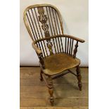 An early 20th century Windsor style kitchen armchair