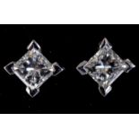 A pair of 18ct white gold and princess cut diamond four claw stud earrings, 0.74ct (total)