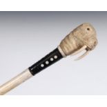 A 19th century marine ivory walking stick, the handle carved in the form of a walrus, on a whalebone