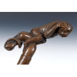 A one piece folk art walking stick, of good proportions, with a monkey, its tail entwined around a