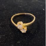 A yellow gold and two stone diamond crossover ring, approx. ring size I½