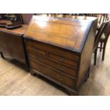 A George III walnut bureau, of small proportions, the fall front revealing a fitted interior with