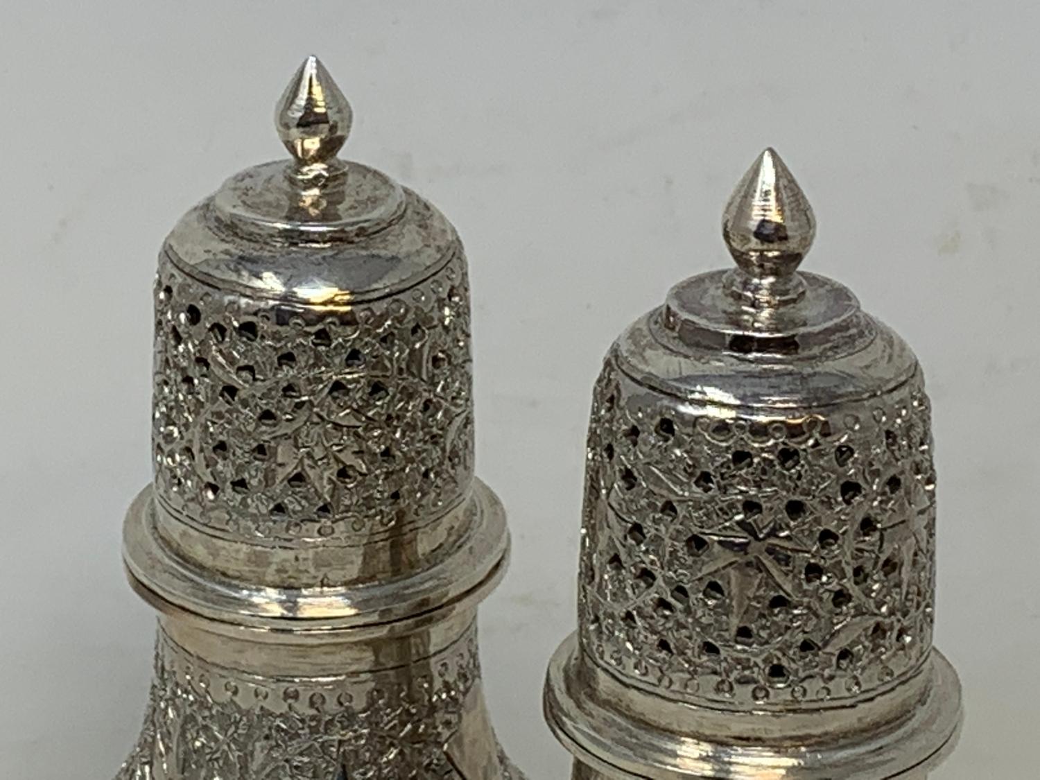 A pair of Burmese style silver coloured metal sugar casters, 15.5 cm high (2) Report by RB 8.6 ozt - Image 5 of 5