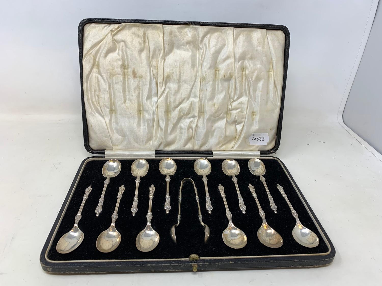 A set of twelve silver teaspoons, with matching sugar tongs, having apostle finials, Sheffield 1927,