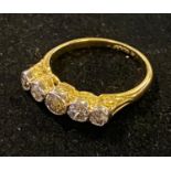 An 18ct gold and diamond five stone ring, approx. ring size L½, 3.3 g (all in) the diamonds are in a