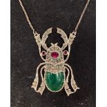 A silver scarab beetle necklace Report by RB Modern