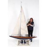 A large painted wood model, of a yacht, approx. 255 cm high, on a stand