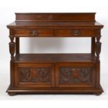 A late Victorian Maple & Co Ld oak buffet, having two frieze drawers on carved and turned