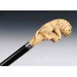 A 19th century walking stick, with a carved ivory handle in the form of a lion sitting on a