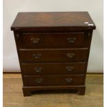 A George III style bachelor chest, veneered in mahogany, the fold over top above four graduated long