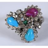 An 18ct gold, diamond, turquoise, garnet and emerald cocktail ring, approx. ring size R, 7.6 g (