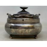 An early 19th century silver tea caddy, of compressed rounded rectangular form, on four ball feet,