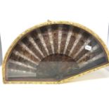 A faux tortoiseshell fan, in a wall mounted fan box, 54 cm wide