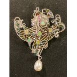 An Art Nouveau style silver pendant/brooch, with opals, rubies and marcasite