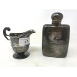 A silver hip flask, initialled, marks rubbed, and a silver cream jug, 8.5 ozt (2)