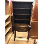 An unusual early 20th century oak bookcase on a table base with a single dropleaf, 65 cm wide