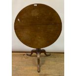 A George III mahogany tripod table, the tilt top on a vase turned column, 79 cm diameter