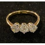 An 18ct gold and three stone diamond ring, approx. ring size J½, 2.7 g (all in) diamonds approx. 4.