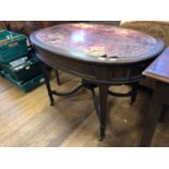 An Edwardian oval mahogany writing table, having a leather inset top, two end frieze drawers and