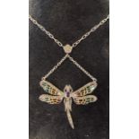A silver dragonfly necklace set, with an oval amethyst and ruby eyes