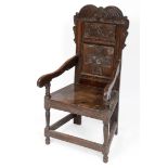 An oak Wainscot armchair, the back carved foliage, initialled MA and dated 1665 Report by RB from