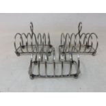 A set of three silver toast racks, London 1964, one lacks the ring handle, 6.6 ozt (3)