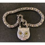 A silver bracelet, with an owl padlock Report by RB Modern