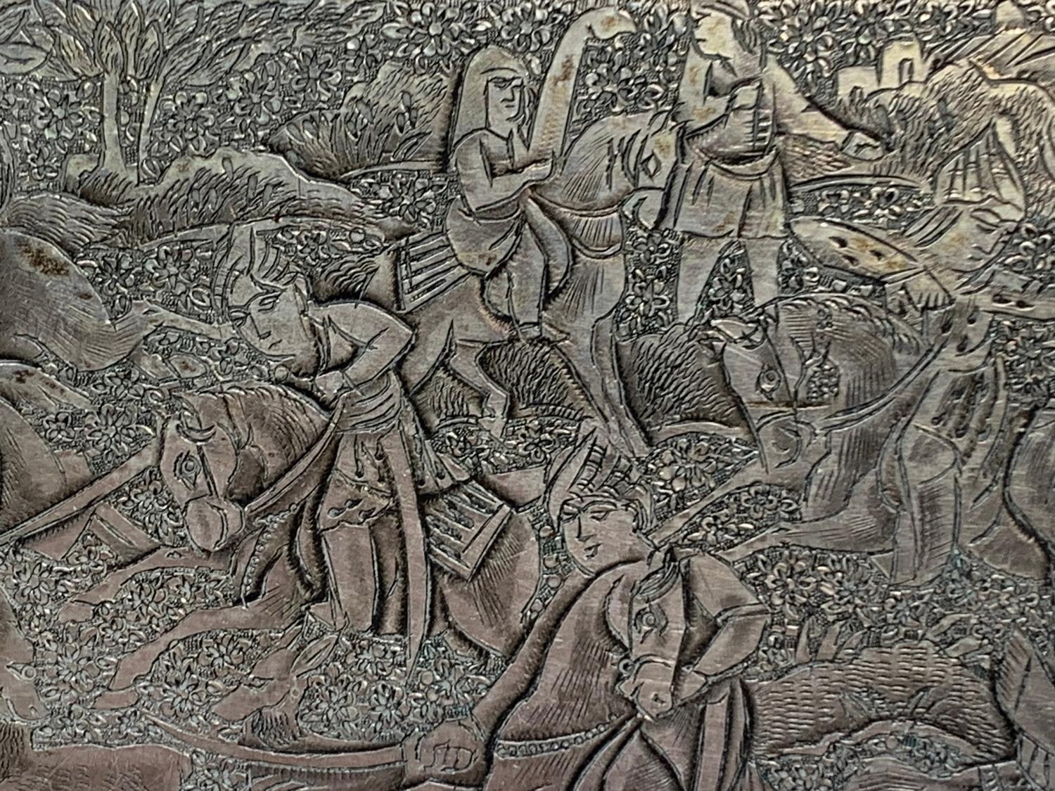 A Persian silver coloured metal cigarette case, decorated figures on horseback hunting lions and - Image 2 of 6