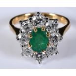 An 18ct white and yellow gold, oval emerald and diamond cluster ring, the central emerald approx.