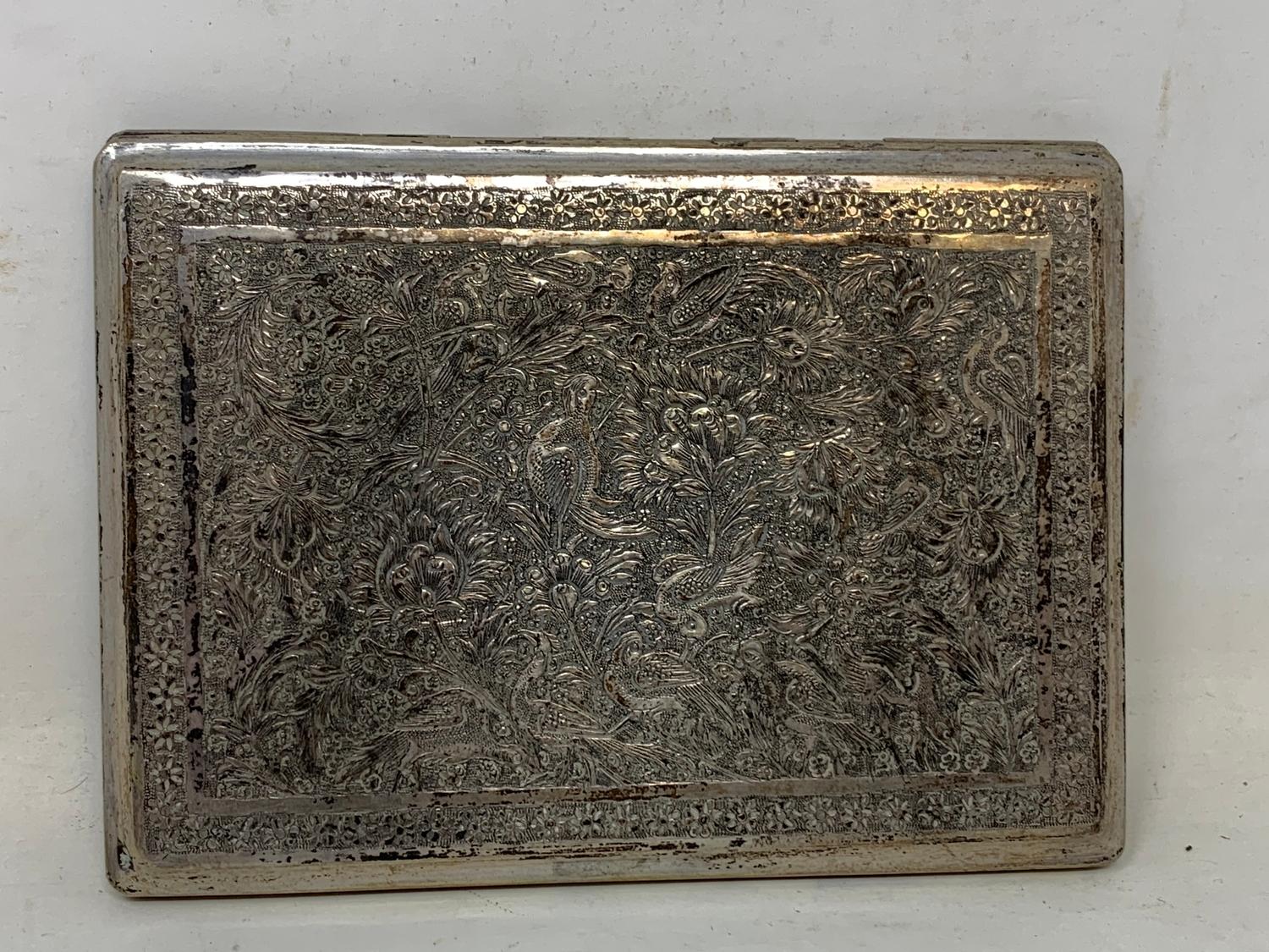 A Persian silver coloured metal cigarette case, decorated birds, flowers and foliage, 11.5 cm wide - Image 5 of 5