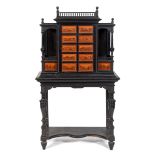A 19th century Continental ebonised specimen cabinet on stand, the cabinet having turned