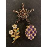 A 9ct gold, amethyst and seed pearl brooch, 3 cm wide, a garnet star brooch, 4.5 cm wide, and a