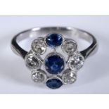 A white metal, diamond and sapphire cluster ring, with a pierced setting, approx. ring size M Report