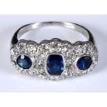 An 18ct gold, diamond and sapphire triple cluster ring, approx. ring size M Report by RB Sapphires