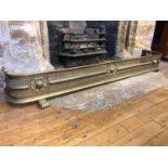 A Victorian brass fender, of unusually large length, 168 cm wide