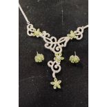A silver and peridot necklace, with matching earrings Report by RB Modern