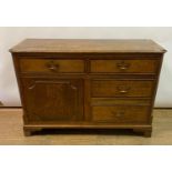 An oak dresser base, having an arrangement of four drawers and a cupboard door, adapted from a