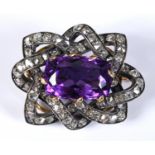 An amethyst and diamond brooch, the central amethyst weighing approx. 8.73ct within a framework of