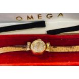 A lady's 9ct gold Omega wristwatch, on a 9ct gold strap, 18.7 g (all in), and an Omega box