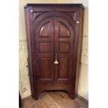 A George III oak floor standing corner cupboard, with a pair of panel doors, 108 cm wide Overall