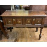 An oak dresser base, having two frieze drawers, on turned legs, reduced from a larger dresser