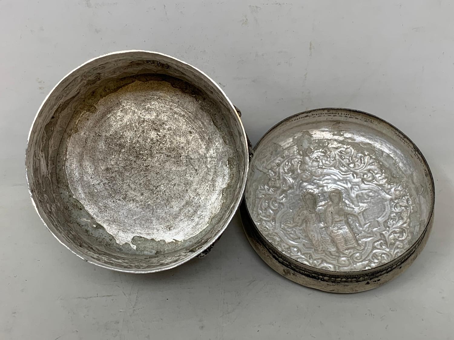 A Burmese silver coloured metal cylindrical box and cover, embossed figures, the base engraved a - Image 8 of 8