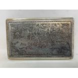 A Persian silver coloured metal cigarette case, decorated figures on horseback hunting lions and