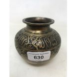 An Islamic brass vessel, of compressed baluster form, decorated foliage and calligraphy, 9 cm high