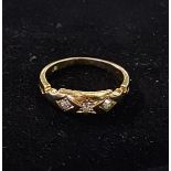 An 18ct gold and three stone diamond ring, approx. ring size L½, 3.7 g (all in)