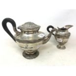 A Continental silver coloured metal teapot, with a bird spout, lacks finial, and a matching milk jug